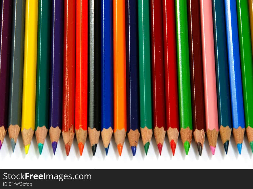 Colourful pencils line up over white. Colourful pencils line up over white