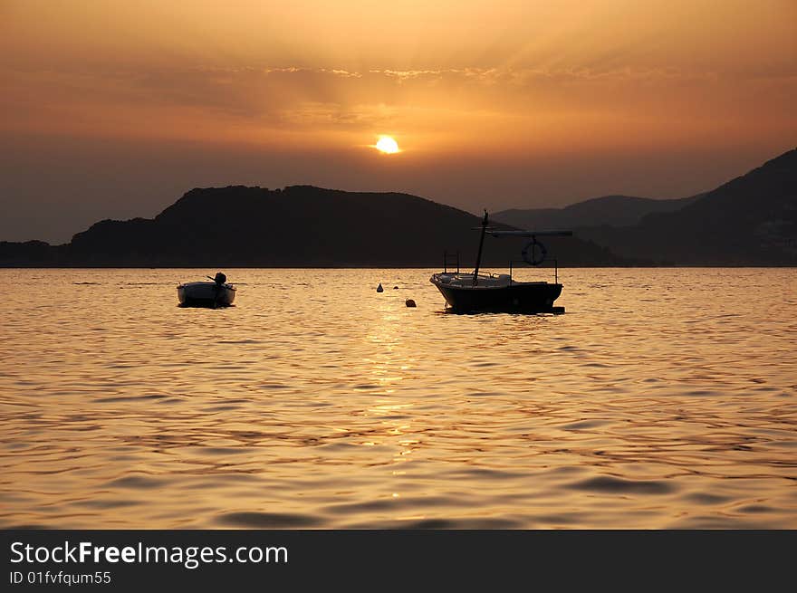 Two boats at sunset. Montenegro. Two boats at sunset. Montenegro