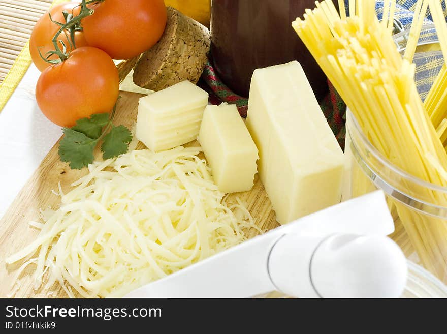 Overhead shot of grated cheese on wooden board