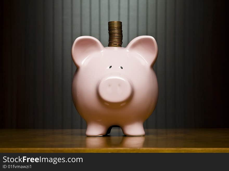 Stack of pennies placed on a piggy bank