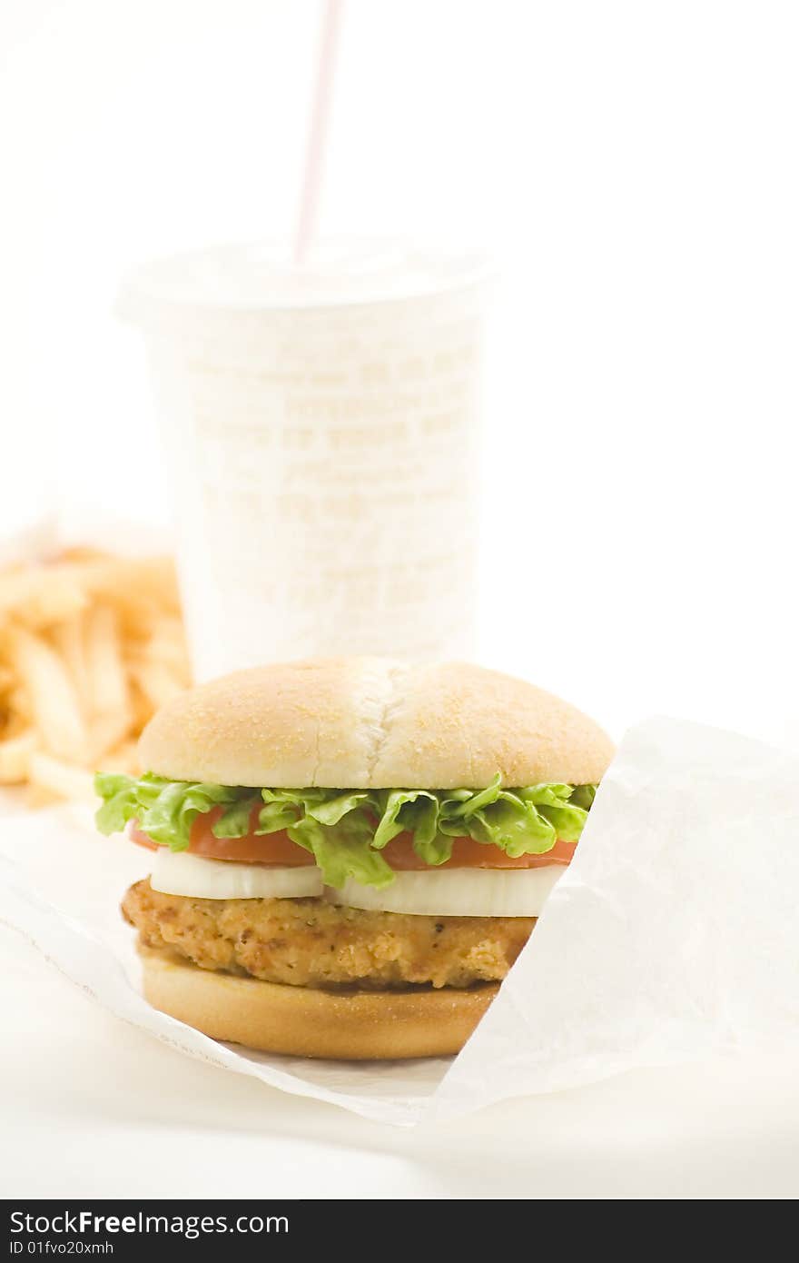 Crisp chicken burger with tomato onion cheese lettuce isolated. Crisp chicken burger with tomato onion cheese lettuce isolated