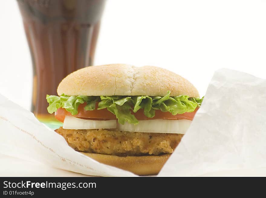 Crisp chicken burger with tomato onion cheese lettuce isolated. Crisp chicken burger with tomato onion cheese lettuce isolated