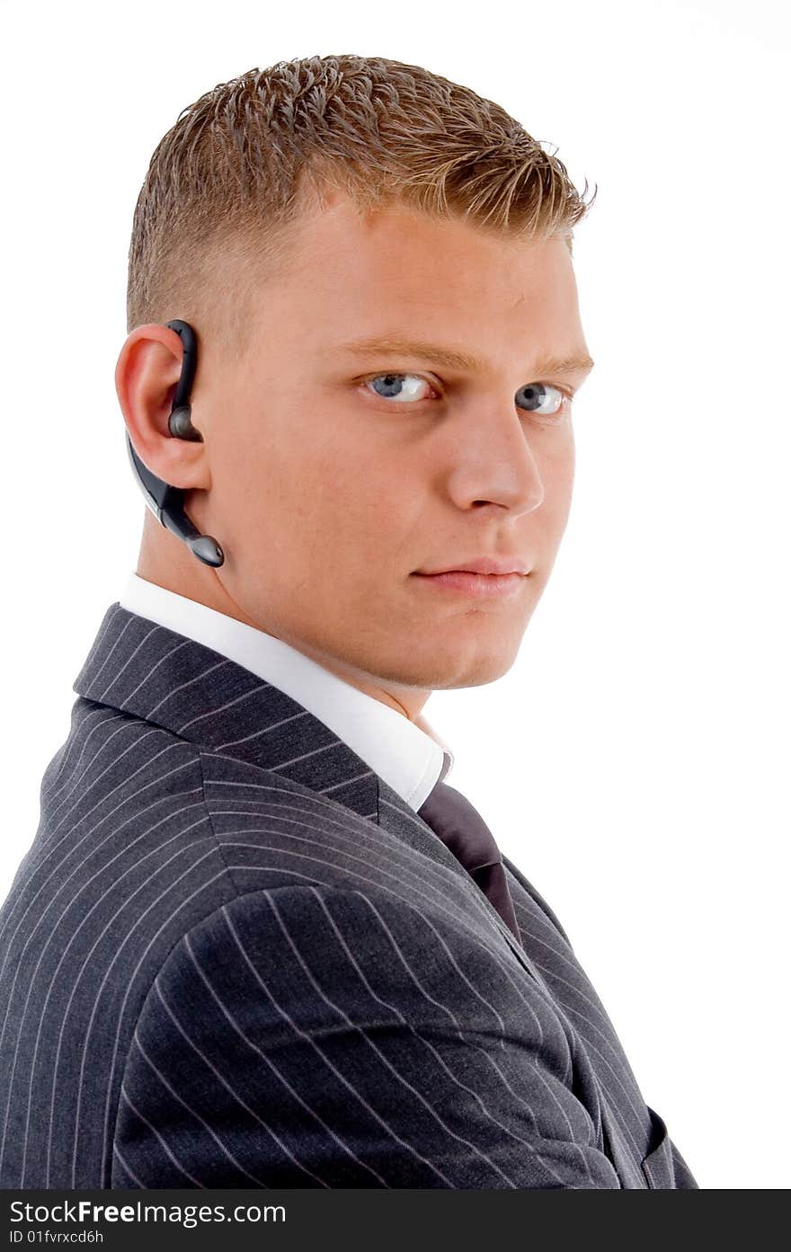 Serious businessman posing with bluetooth on an isolated white background. Serious businessman posing with bluetooth on an isolated white background