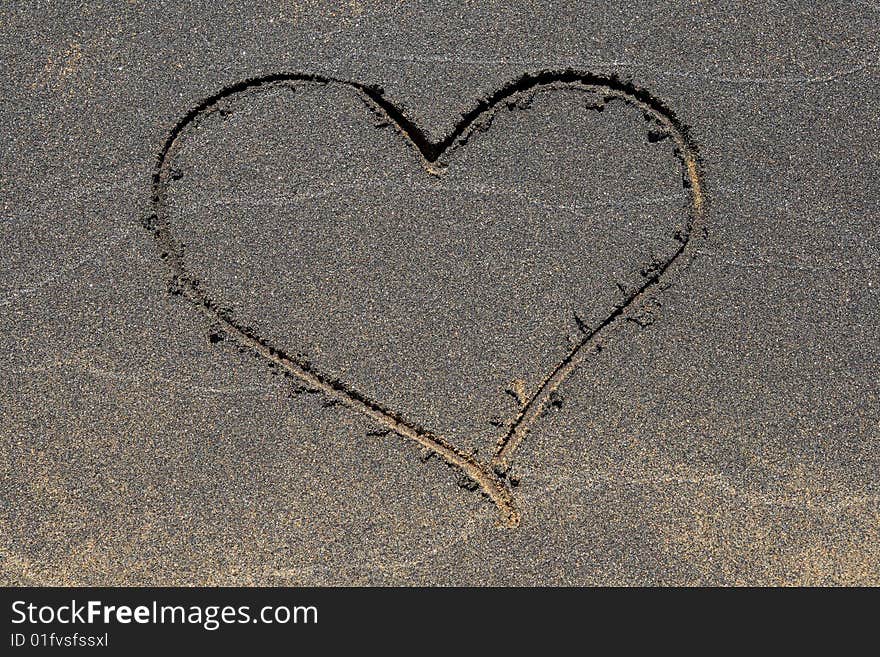 Heart symbol drawn in the black sand beach. Heart symbol drawn in the black sand beach.