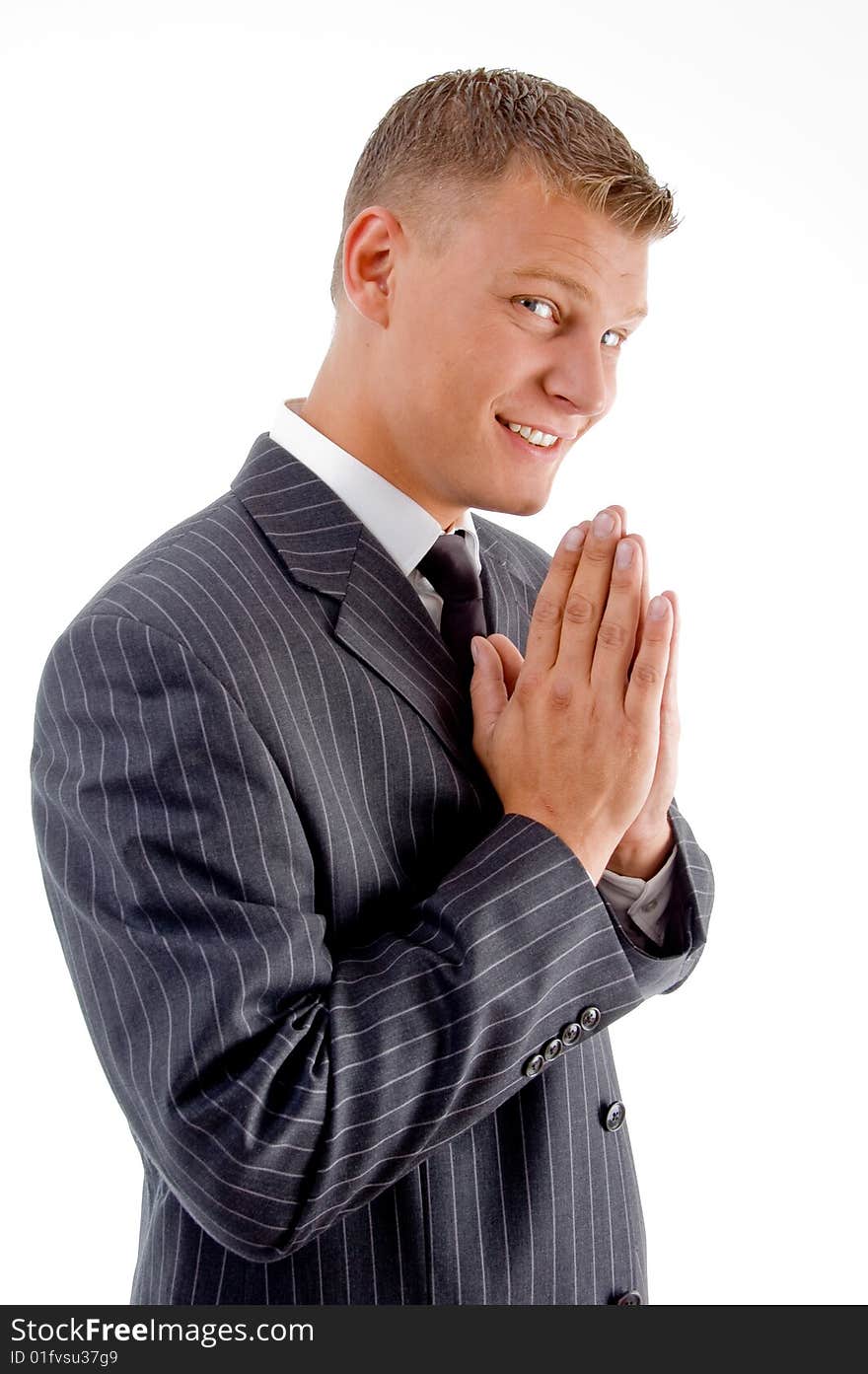 Smiling praying businessman on an isolated background