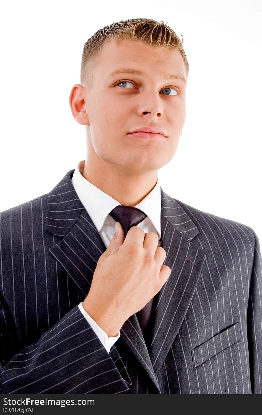 Businessman adjusting his tie on an isolated white background