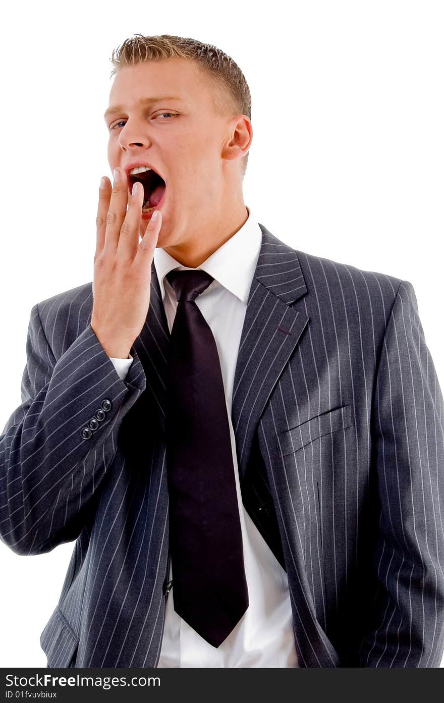 Yawning young businessman against white background