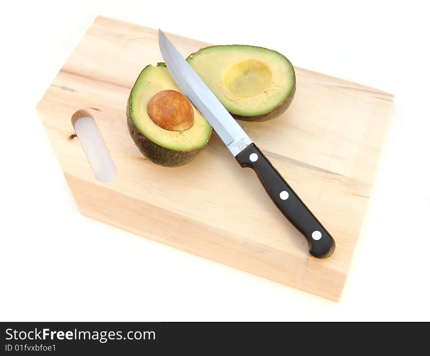 Avocado with pit and knife