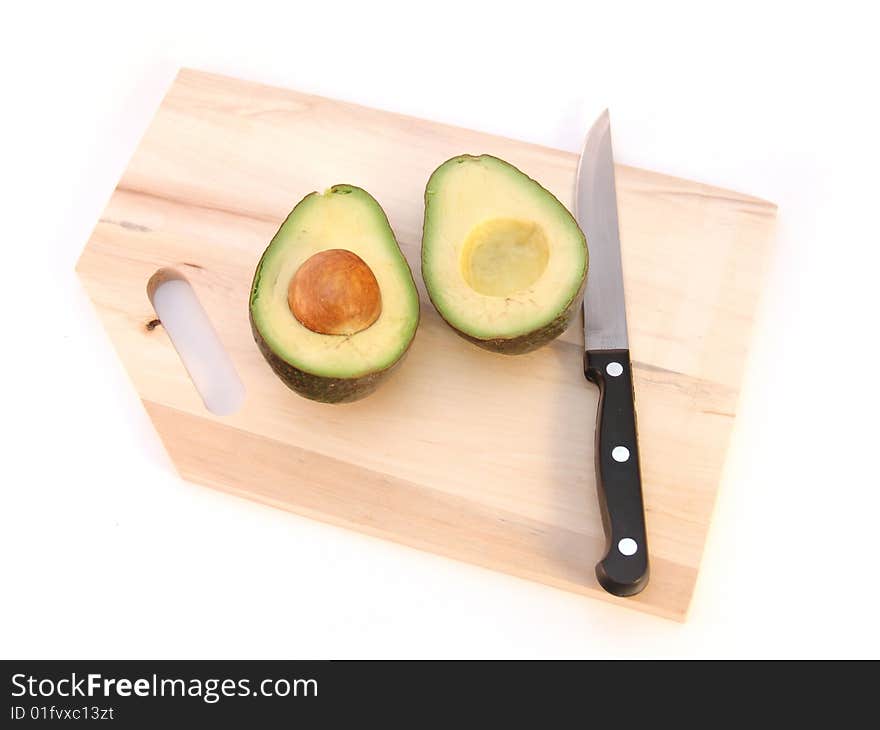 Avocado cut in half with pit isolated over white. Avocado cut in half with pit isolated over white