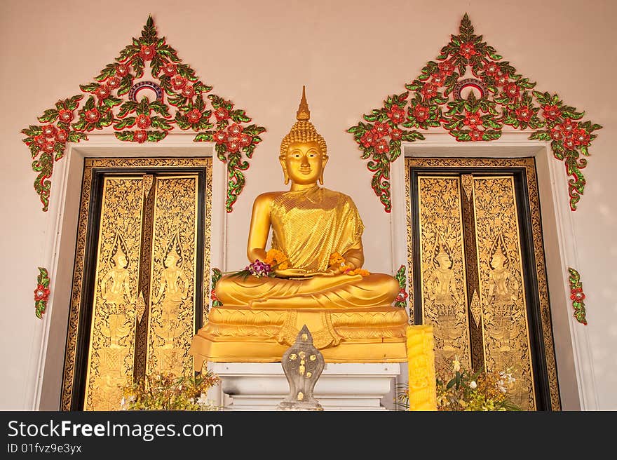 Buddha image with two Thai style gold doors of church in Thai temple. Buddha image with two Thai style gold doors of church in Thai temple.