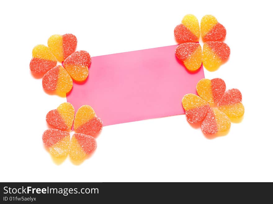 Congratulatory card with yellow-red fruit candy in the form of hearts