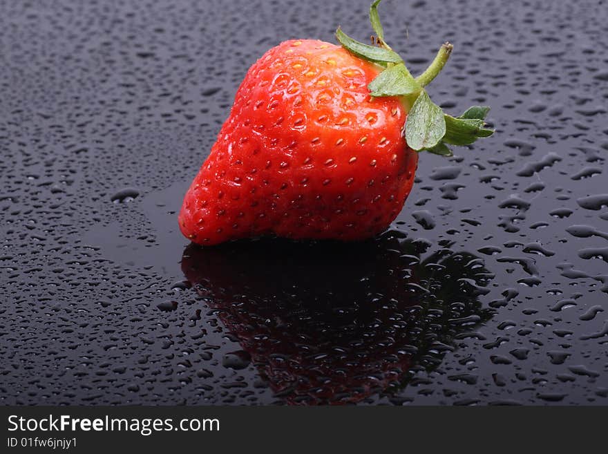 Fresh ripe strawberries isolated on the dark background.