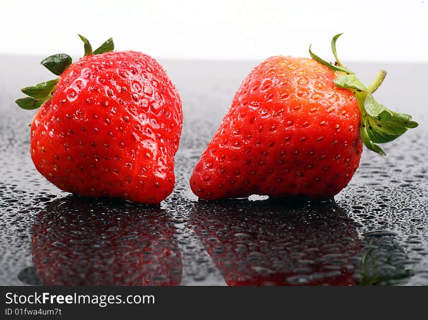 Fresh ripe strawberries isolated on the dark background.