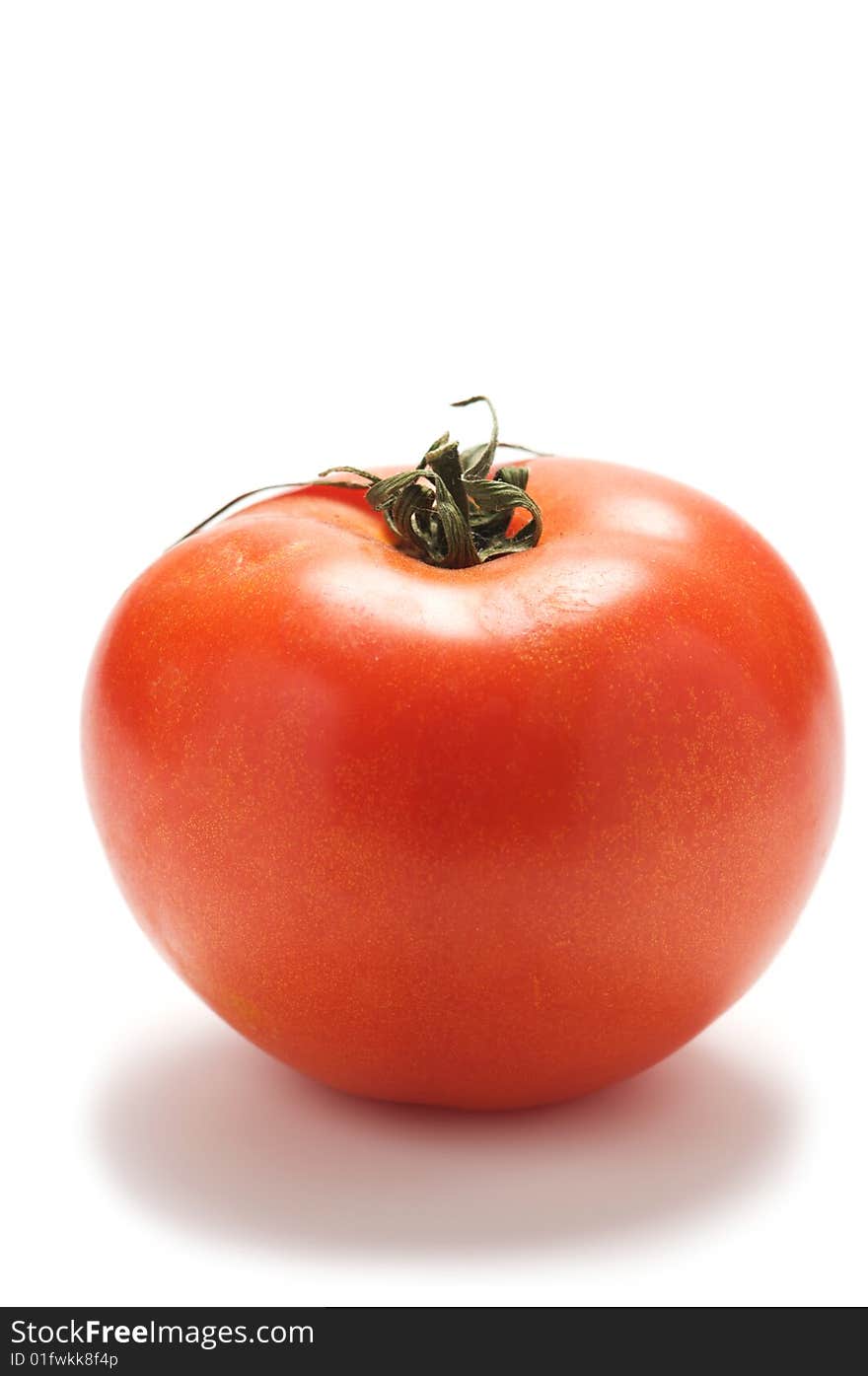 Large red tomato isolated on a white background.