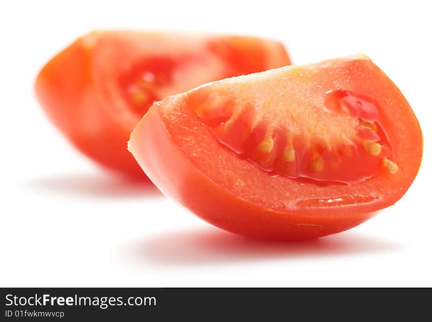 A piece of tomato isolated on a white background. Background blurry.