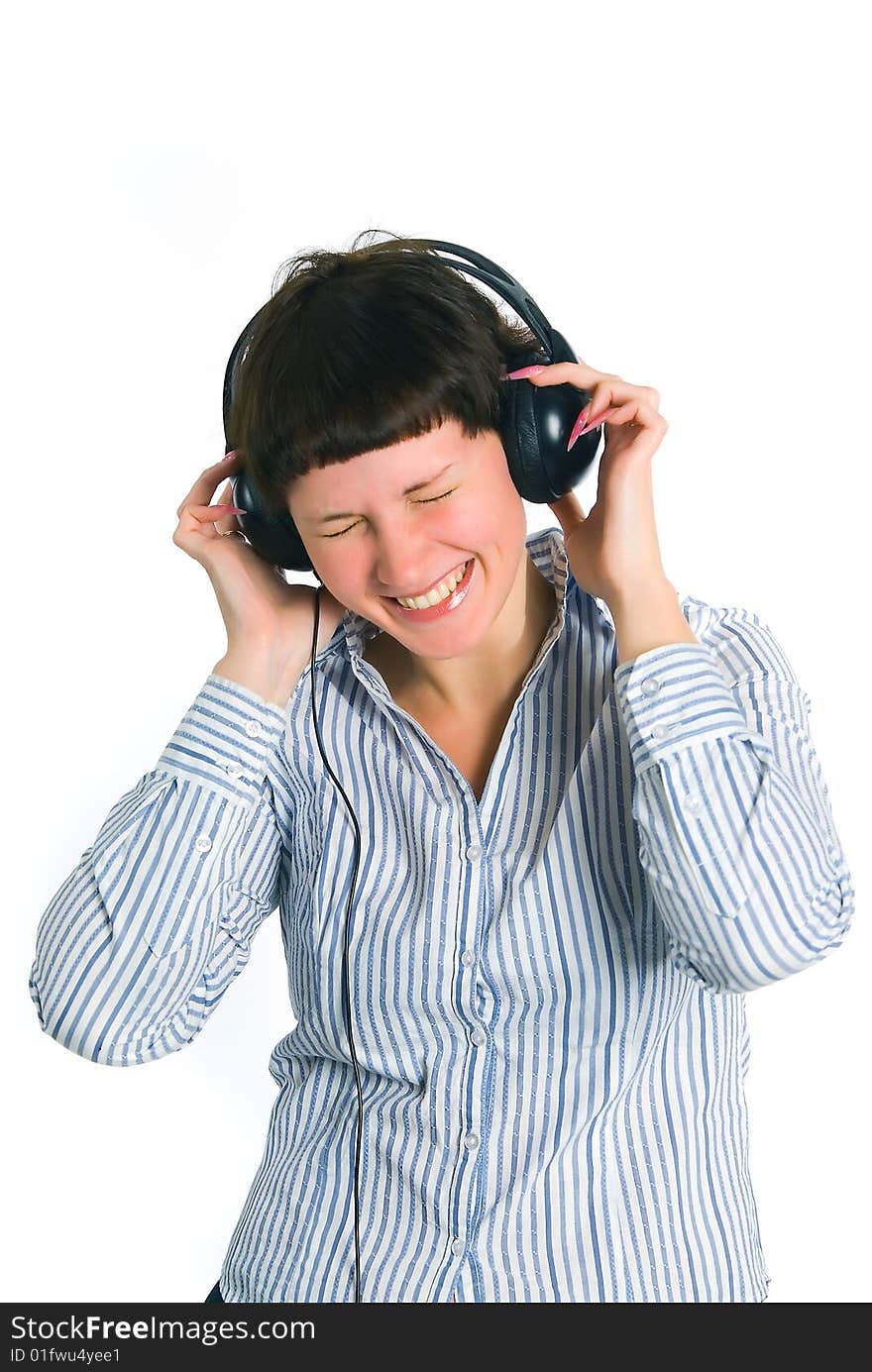 The girl listens to music on a white background