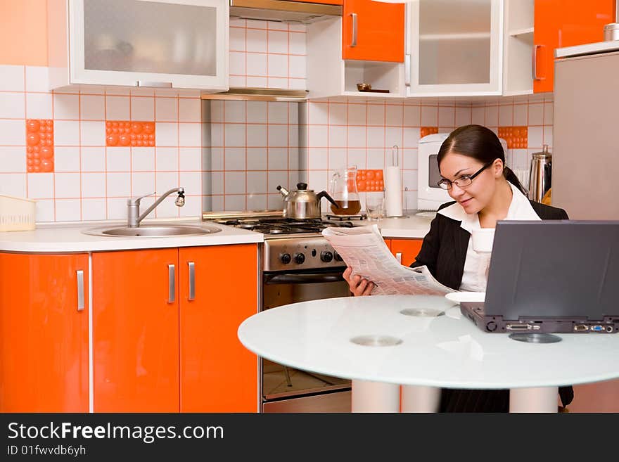 Attractive brunette businesswoman in modern kitchen. Attractive brunette businesswoman in modern kitchen