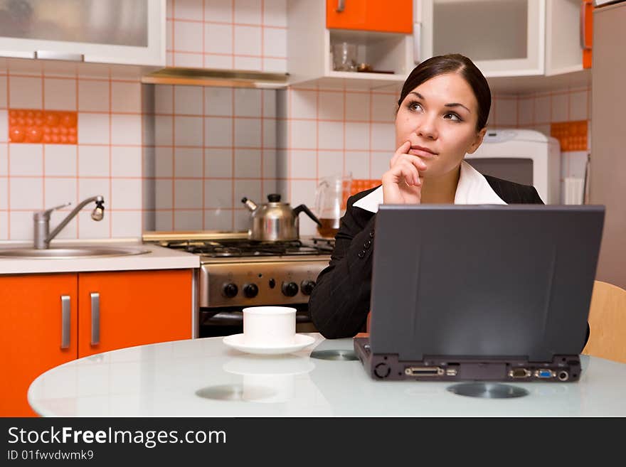 Attractive brunette businesswoman in modern kitchen. Attractive brunette businesswoman in modern kitchen