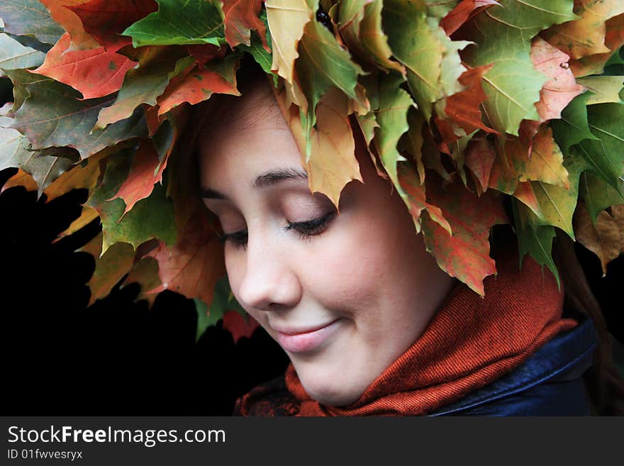 Girl has yellow and green leaves at the head. Girl has yellow and green leaves at the head