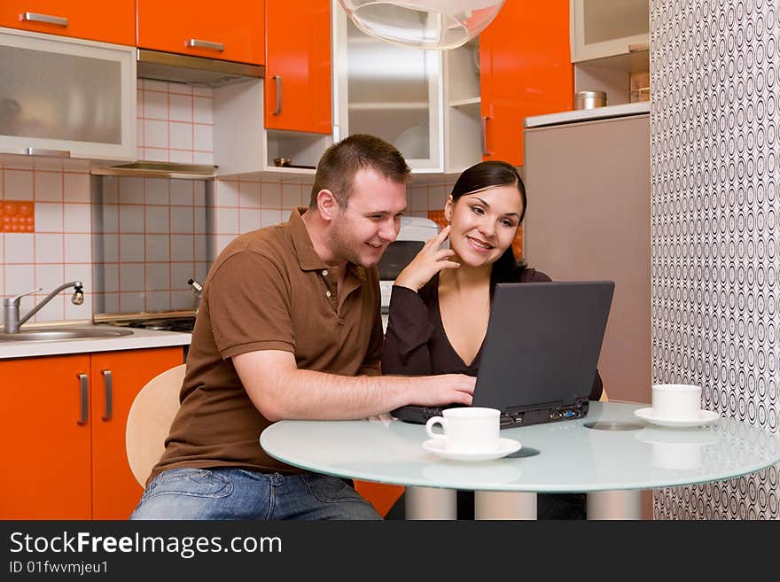 Happy couple together in modern kitchen