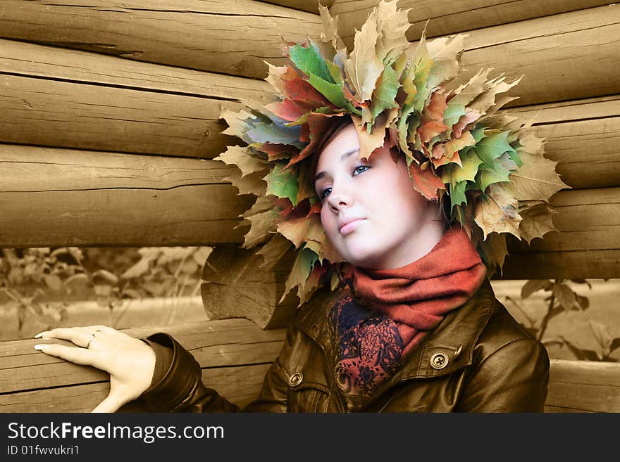 Girl With Autumn Leaves At The Head