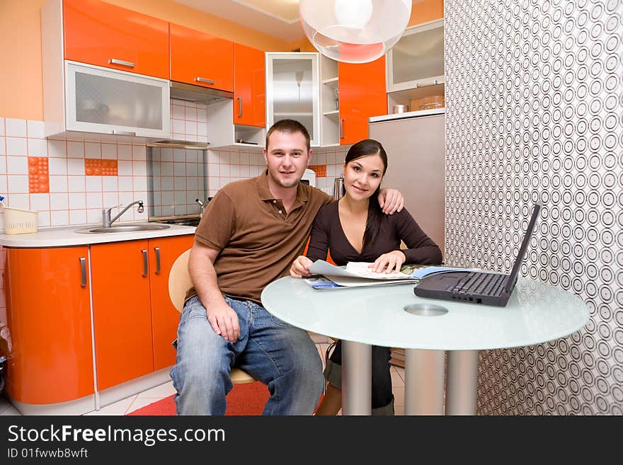 Happy couple together in modern kitchen