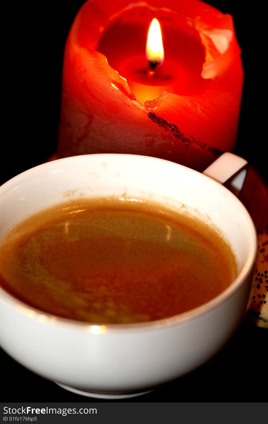 Cup coffee and candle in the dark