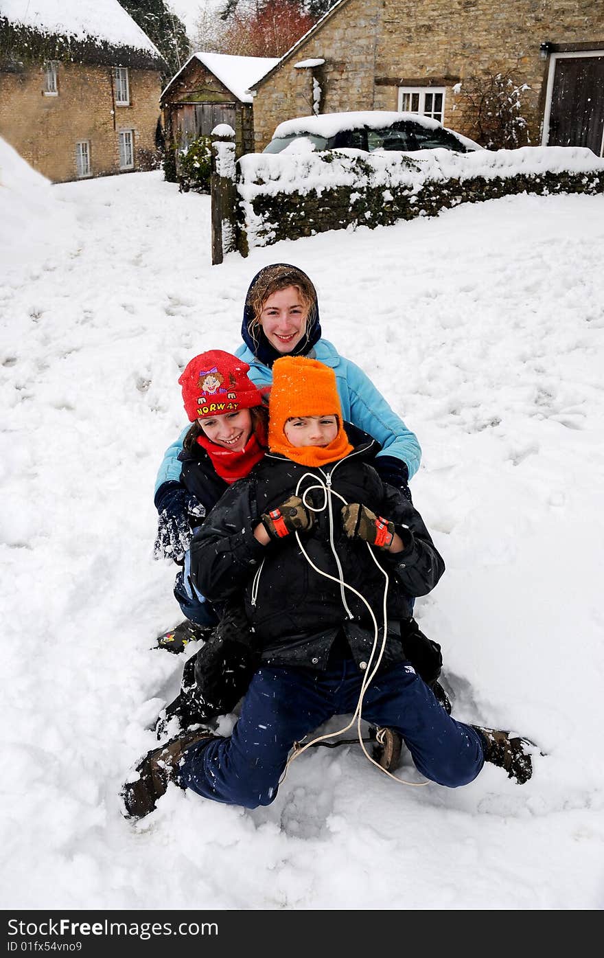 Children on a toboggan in the snow. Children on a toboggan in the snow