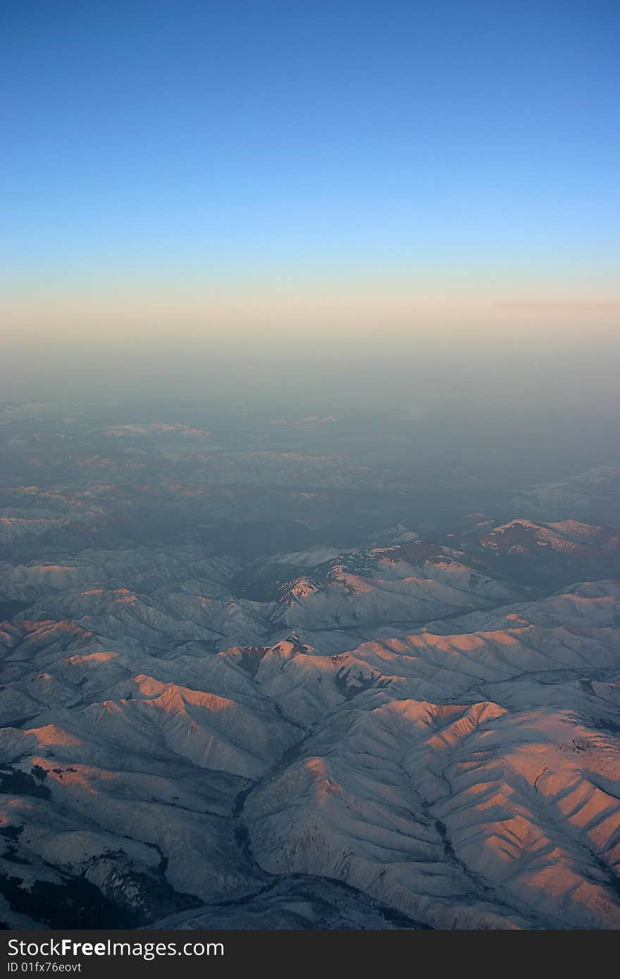 A aerial view of mountains over Siberia with horizon. A aerial view of mountains over Siberia with horizon