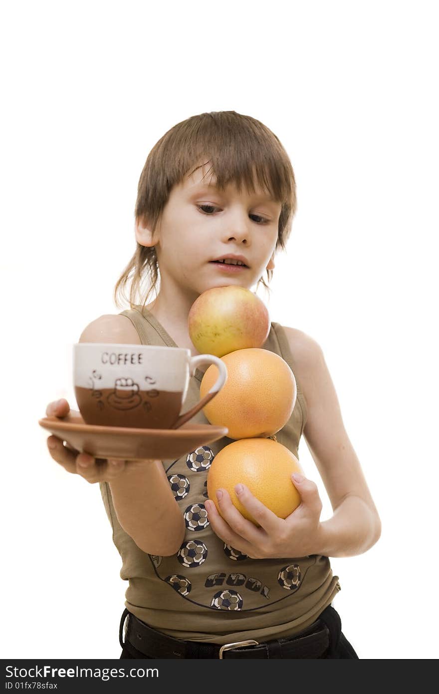 Young boy hold an apple and two grapefruits and cap of coffee. Young boy hold an apple and two grapefruits and cap of coffee