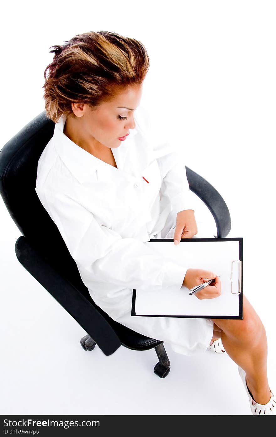 Female doctor writing on notepad on an isolated white background