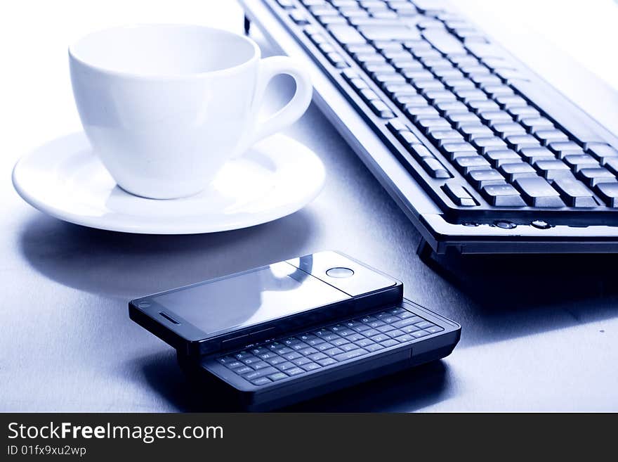 Keyboard, coffee cup and PDA - high key. Keyboard, coffee cup and PDA - high key