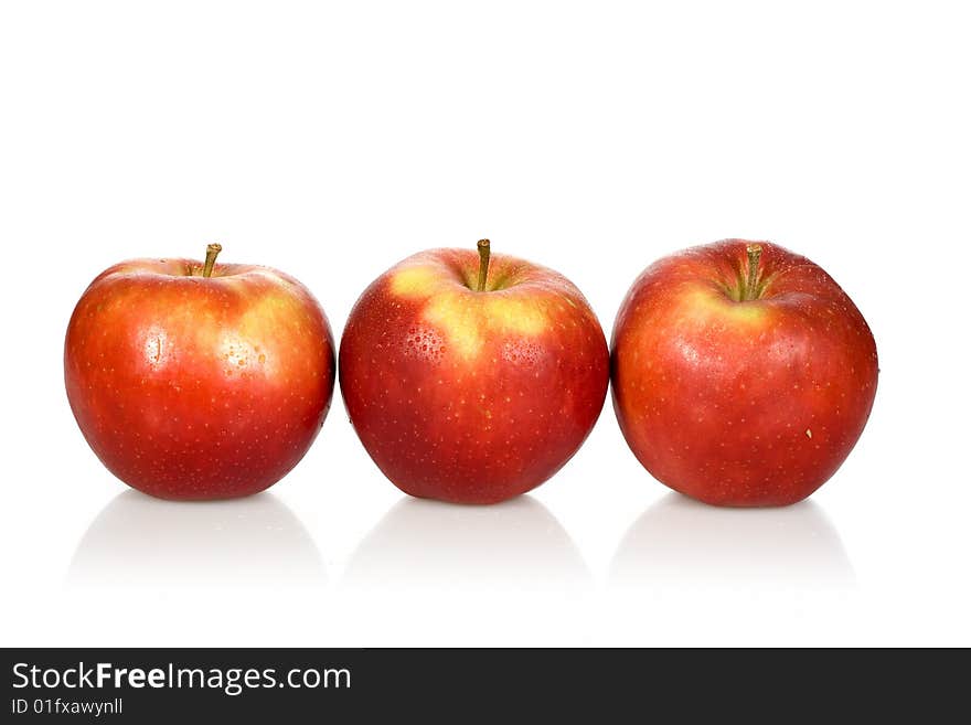 Three wet red apples on a white background - with clipping path