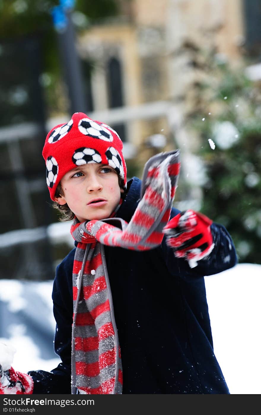 Portrait of boy throwing snowball