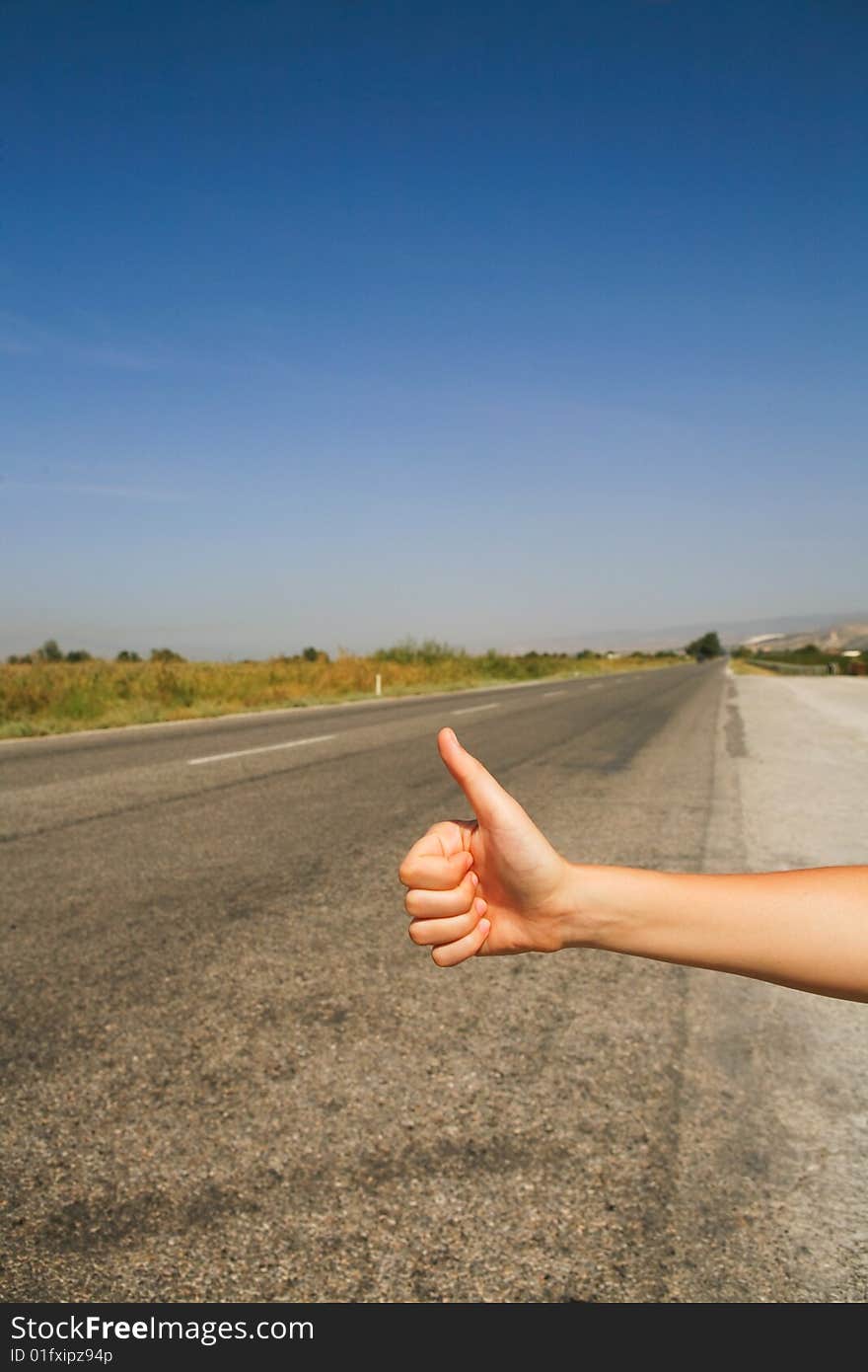 Hitchhiking the road. hot summer day