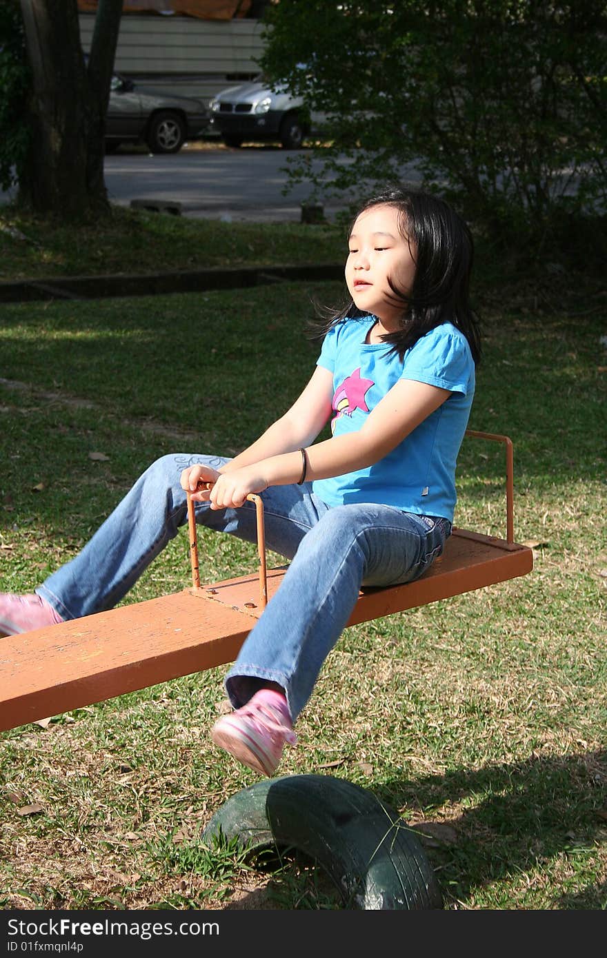 Girl playing seesaw