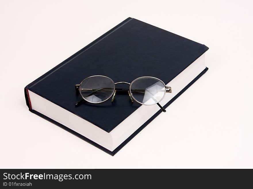 Black book with reading glasses