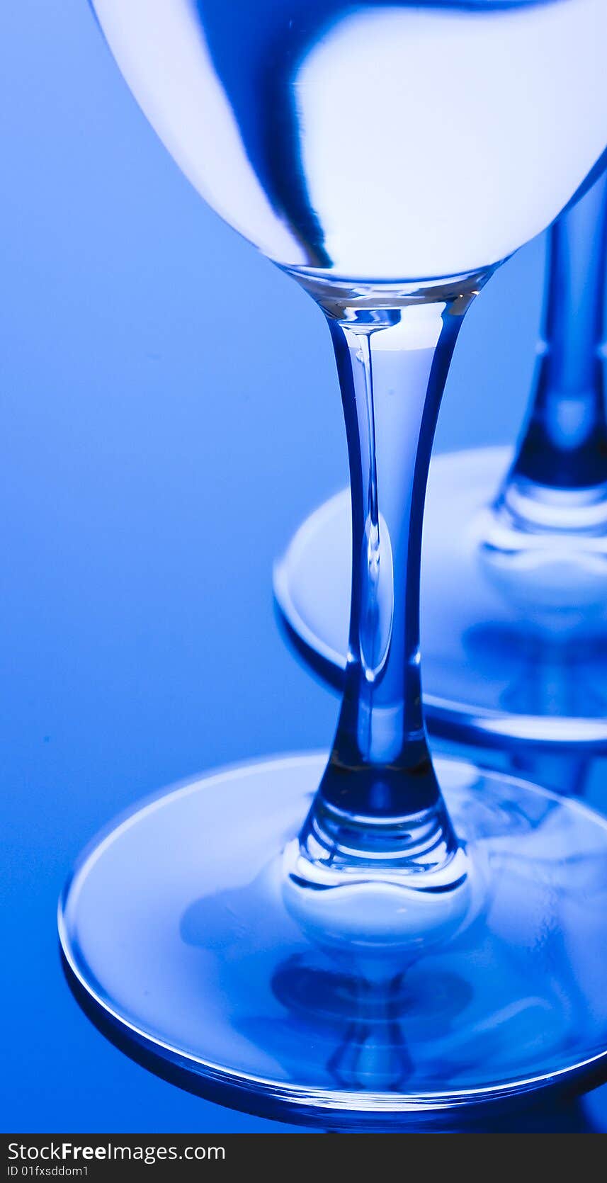 Blue Glass with Splashing water. Coolness Drink