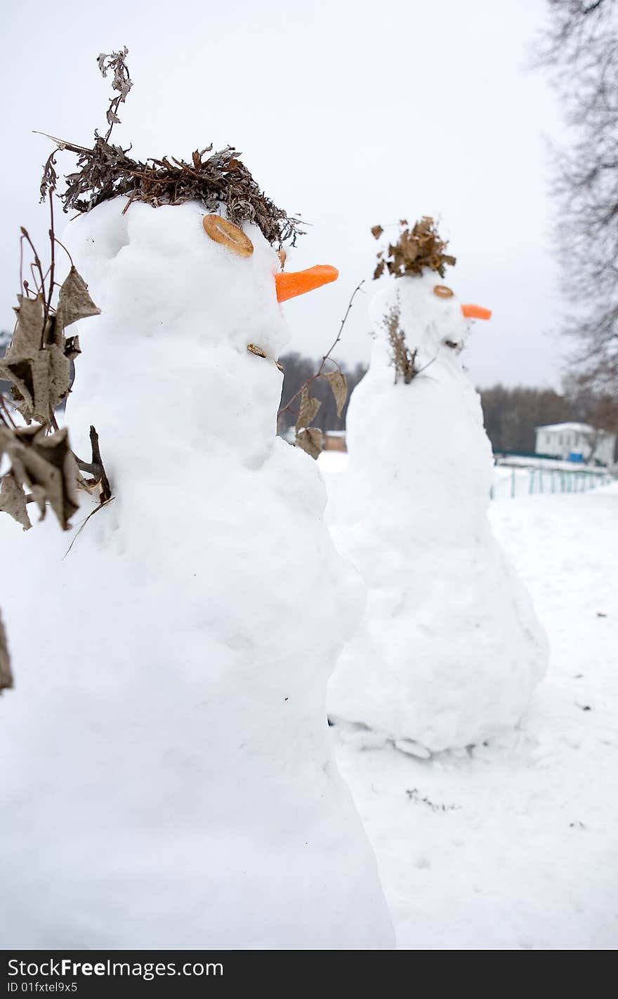 Two white snowmen in park. Two white snowmen in park