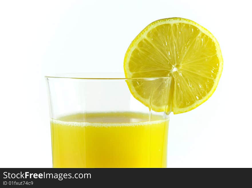 Orange juice in glass and lemon cut. Orange juice in glass and lemon cut