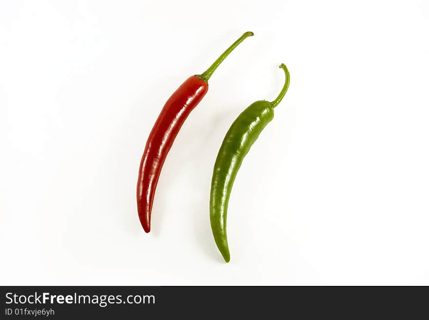 Red and green chillis on white background. Red and green chillis on white background