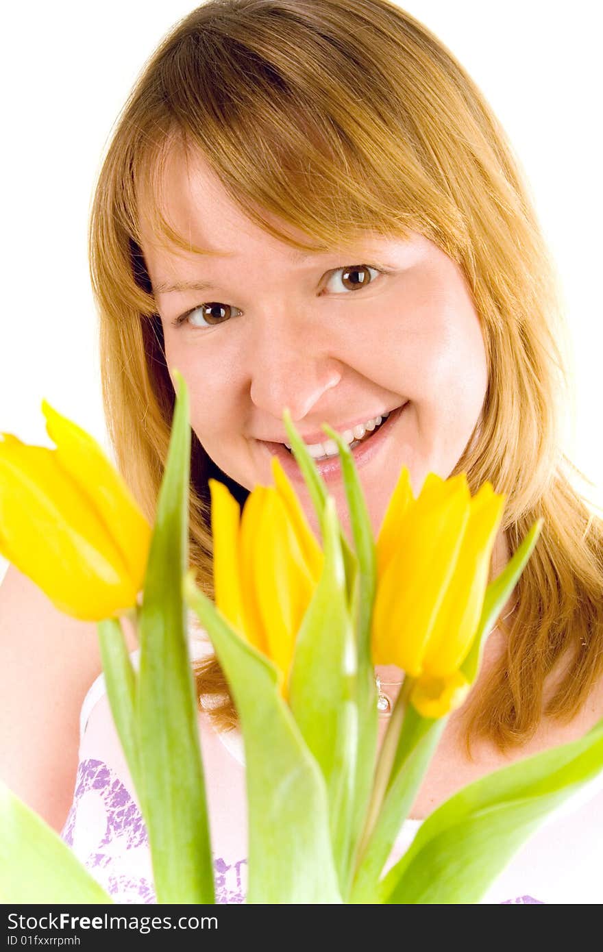 Attractive young woman with yellow tulips