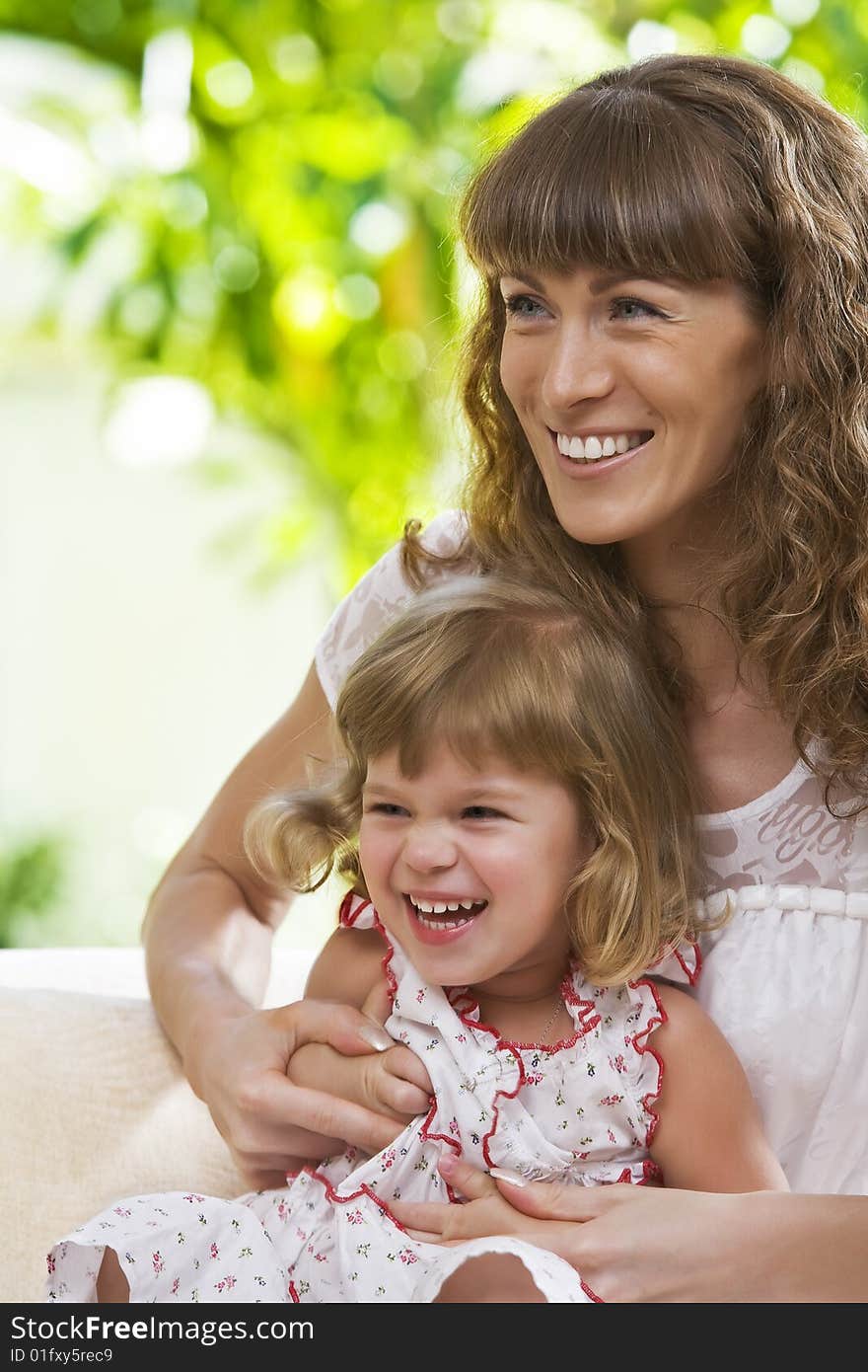 Portrait of happy mother with daughter  having good time in summer environment. Portrait of happy mother with daughter  having good time in summer environment