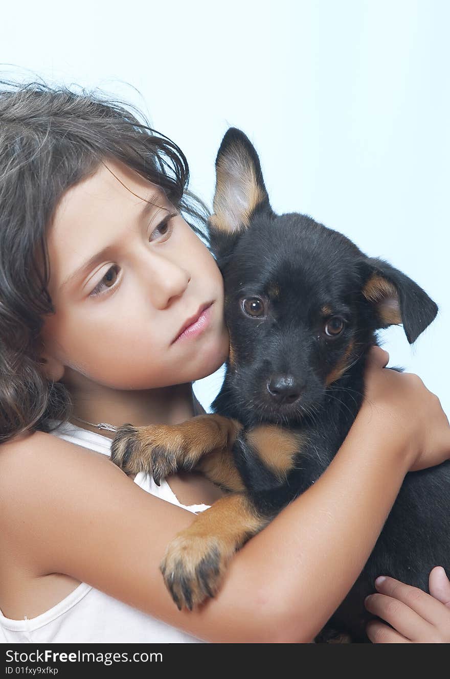 Portrait of little girl having good time with her puppy