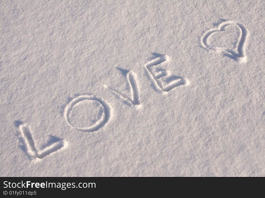 Writing text  LOVE   on the snow