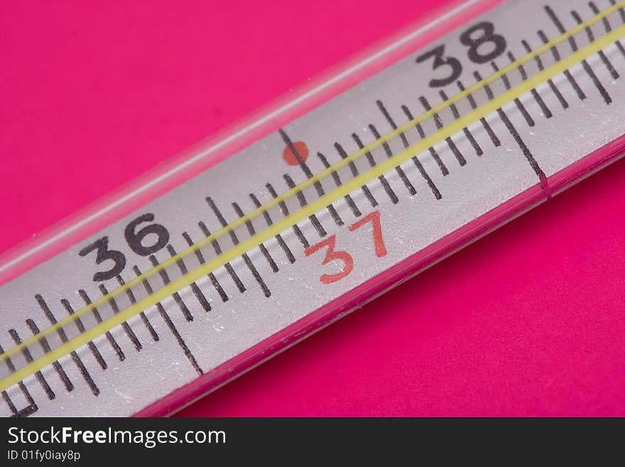 Medical thermometer on a red backgrounds