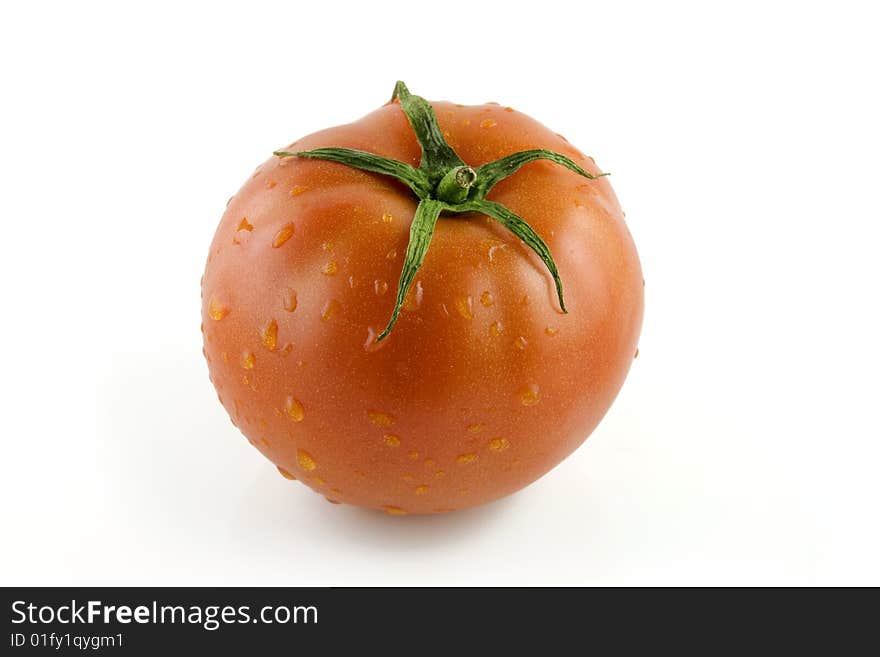 Tomato in water droplets on white backgound