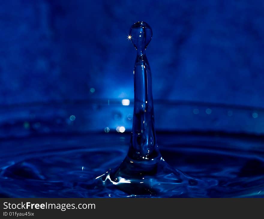 Water drop on dark blue background