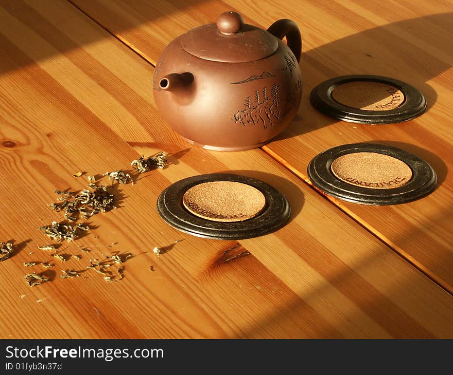 Tea in the teapot on the wooden table sunnely morning