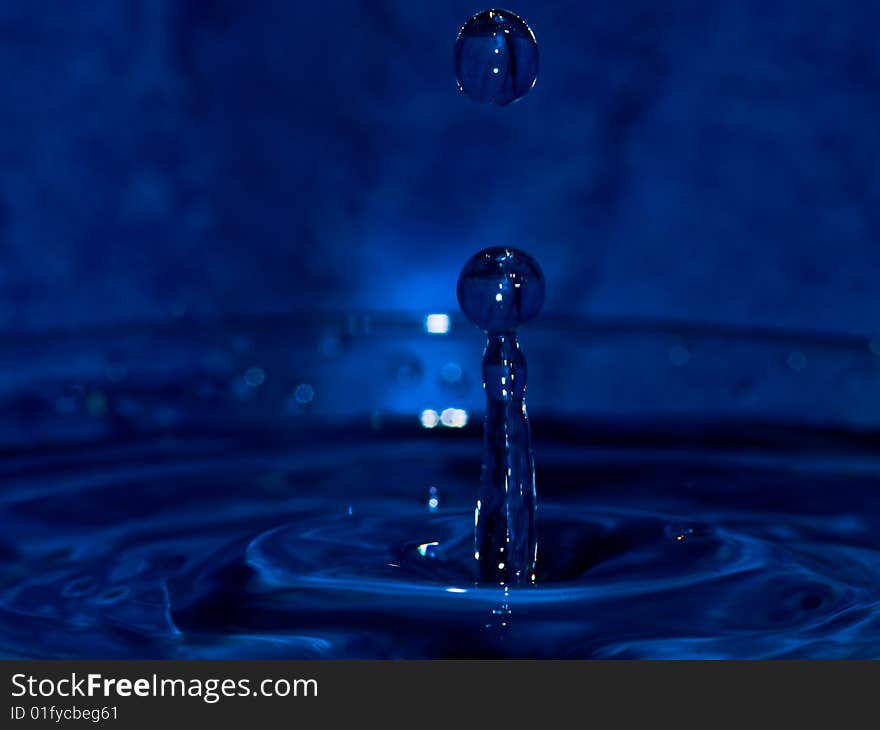 Water drop on dark blue background